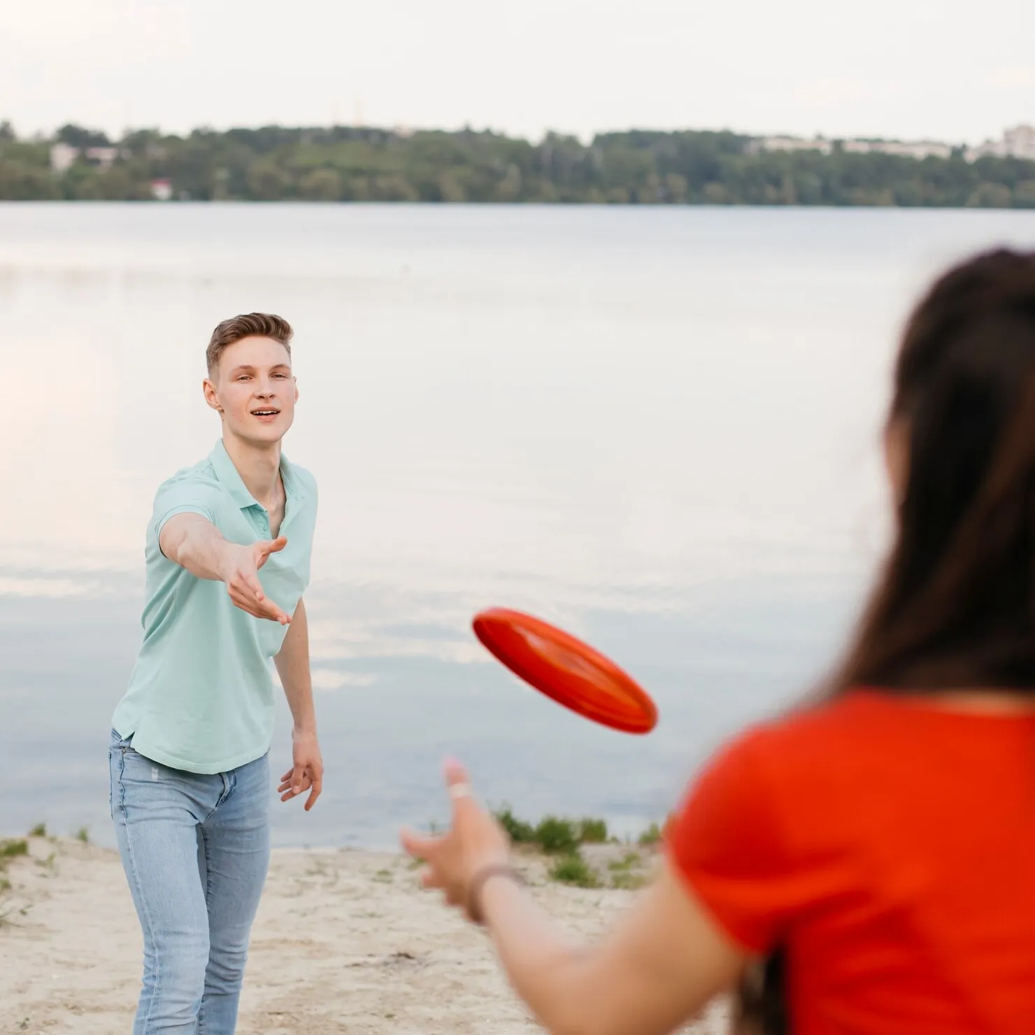 girl-boy-playing-with-red-frisbee_23-2148262414_HNX8