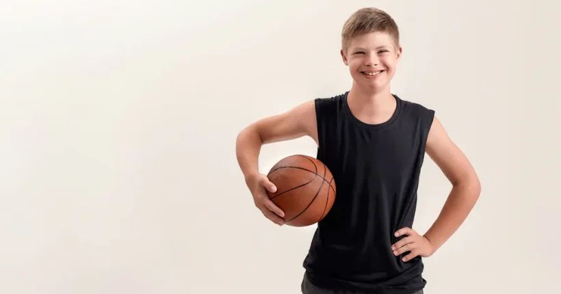 Coach helping build self-confidence in children with special needs through adaptive basketball practice